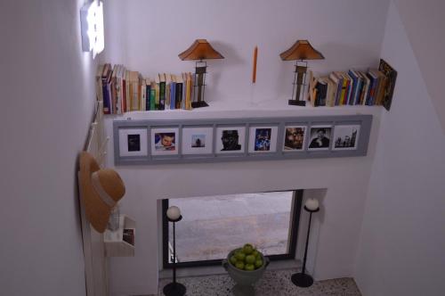 a living room with a fireplace with pictures on it at Musica Guest House in Alghero