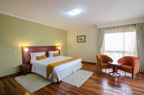En eller flere senge i et værelse på Waridi Paradise Hotel and Suites