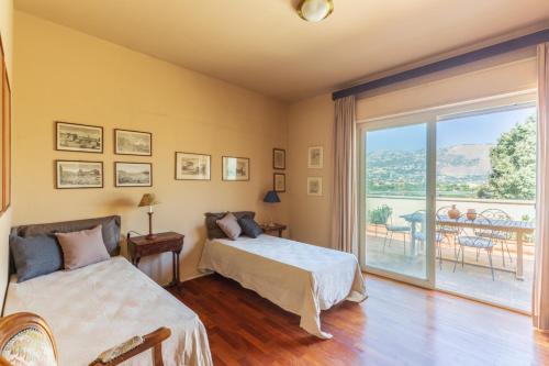 a bedroom with two beds and a balcony at Domus Sicily - Villa Conca d'Oro with Pool in Palermo