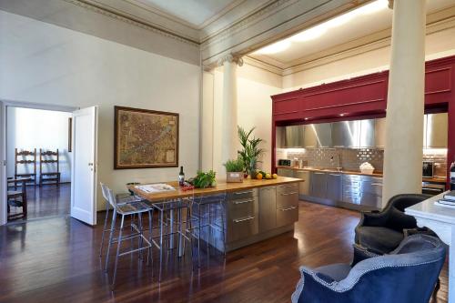 a large kitchen with a bar with stools at Peruzzi Urban Residences in Florence