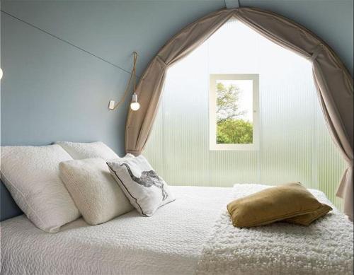 a bedroom with a bed with a large window at COCO TENT in Tuoro sul Trasimeno