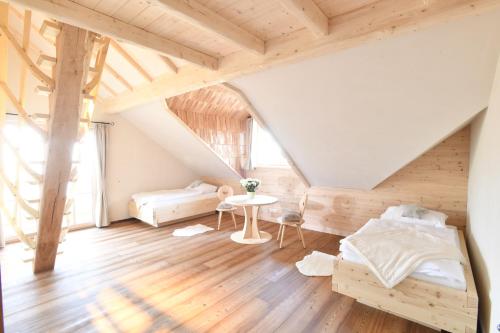 a attic bedroom with a bed and a table at Florineum in Weyregg