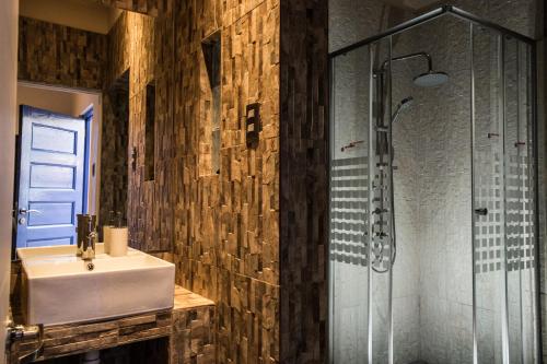 a bathroom with a sink and a shower at Hard Road Atacama in San Pedro de Atacama