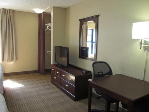 a hotel room with a bed and a desk and a television at Extended Stay America Suites - Boise - Airport in Boise