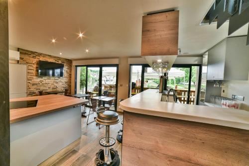 a kitchen with a bar and a dining room at LES TANNERIES in Ornans