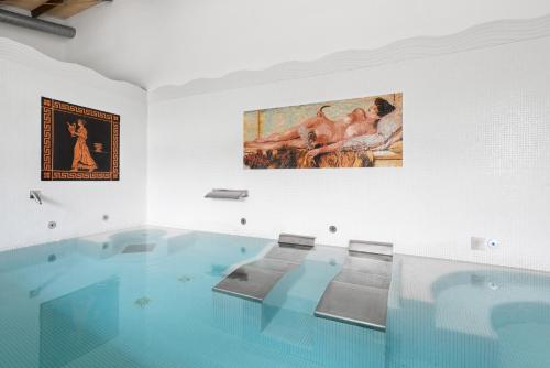 a large swimming pool with a painting on the wall at Áurea Palacio de Sober by Eurostars Hotel Company in Sober
