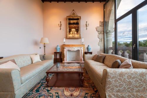 a living room with two couches and a fireplace at Áurea Palacio de Sober by Eurostars Hotel Company in Sober