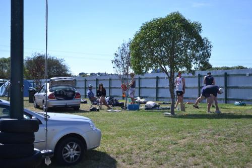 a group of people in a yard with a tree at Westshore Holiday Park in Napier