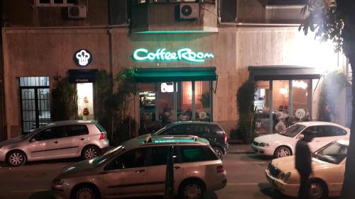 a group of cars parked in front of a restaurant at Apartment Jastuk in Belgrade