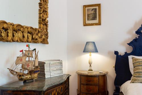 a bedroom with a table with a boat on it at Geronimo Guest House Belém in Lisbon