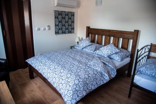 a bedroom with a bed with a blue and white comforter at Penzion a restaurace U Kalendů in Strážnice