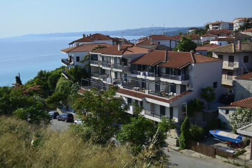 a group of houses on a hill next to the ocean at Arellis in Afitos