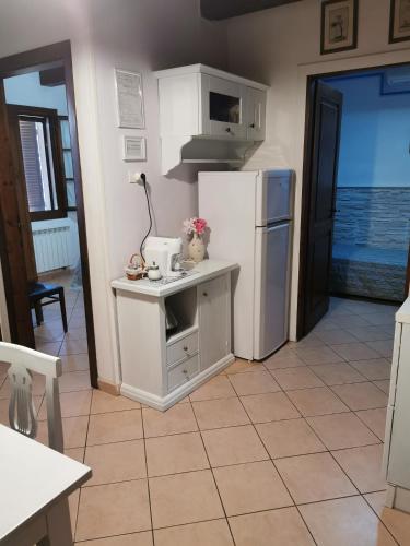 a kitchen with a refrigerator and a counter with a stove at Agriturismo Pettinari in Marina di Grosseto
