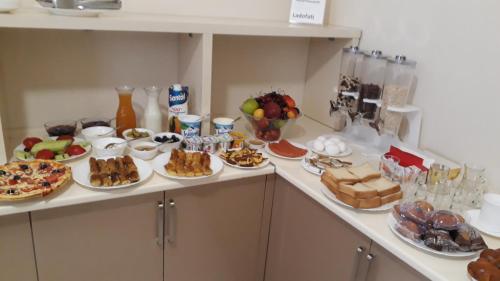 a buffet with many plates of food on a counter at Hotel Tao in Batumi