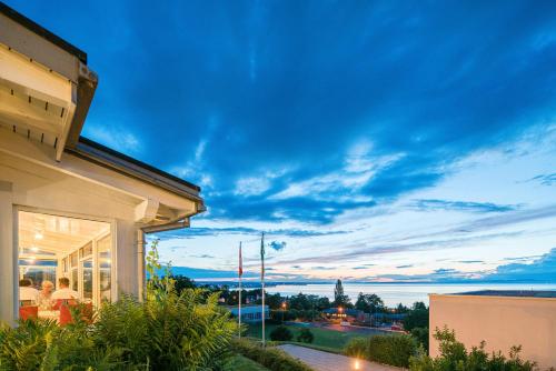 a view of the ocean from a house at Best Western Hotel Rebstock in Rorschacherberg