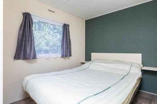 Postel nebo postele na pokoji v ubytování RA Reeënveld Mobile home
