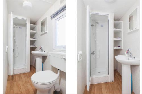 a bathroom with a toilet and a sink and a shower at RA Veluwe Mobile home in Arnhem