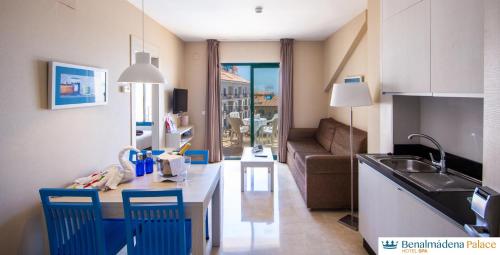 a kitchen and living room with a table and a couch at Benalmadena Palace Spa in Benalmádena