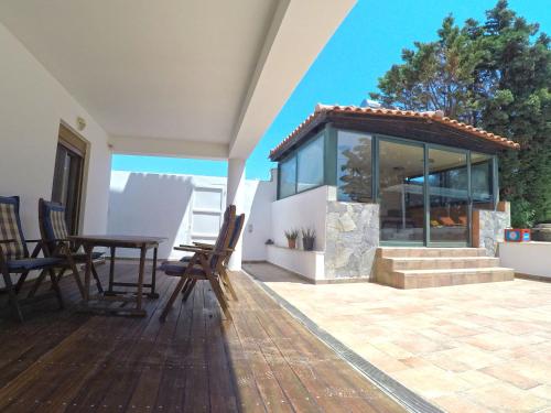 a patio with a table and chairs on a house at Luxury Villa with Private Pool in Keratea