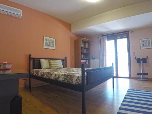 a bedroom with a bed in a room with orange walls at Luxury Villa with Private Pool in Keratea
