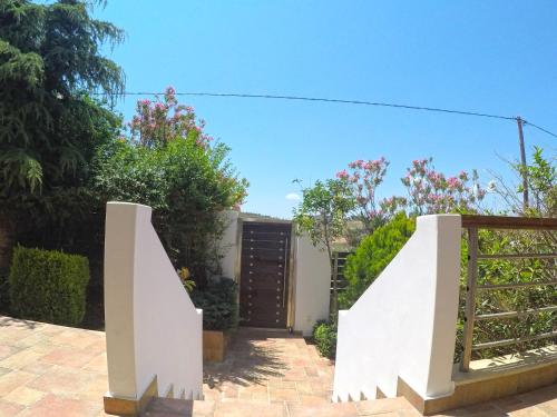 a house with a gate and a stairway at Luxury Villa with Private Pool in Keratea