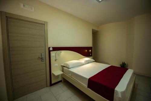 a bedroom with a large bed and a door at Aether Suites Tropea - Free Private Parking in Tropea