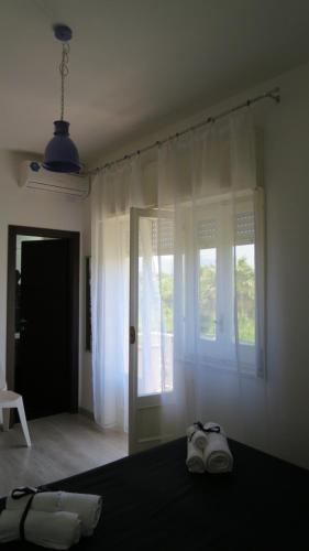 a bedroom with a bed with two towels on it at Idria B&B in Barcellona-Pozzo di Gotto
