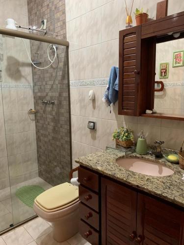 a bathroom with a toilet and a sink and a shower at Refugio de Paz in São Pedro