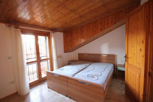 a bedroom with a bed and a large window at Villa Angela in Lido delle Nazioni