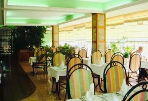 a restaurant with tables and chairs in a room at Hotel Valenca do Minho in Valença