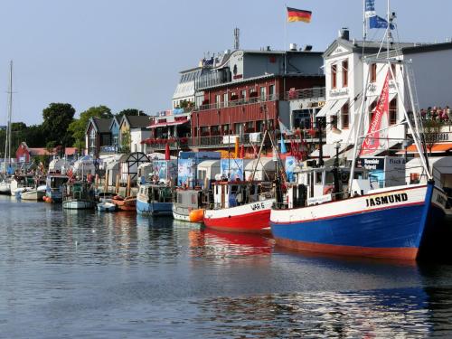 a group of boats are docked in a harbor at Hotel & Gästehaus Rostock Lütten Klein in Rostock