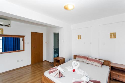 a bedroom with a bed with bows on it at Хотел Лагуна in Chernomorets