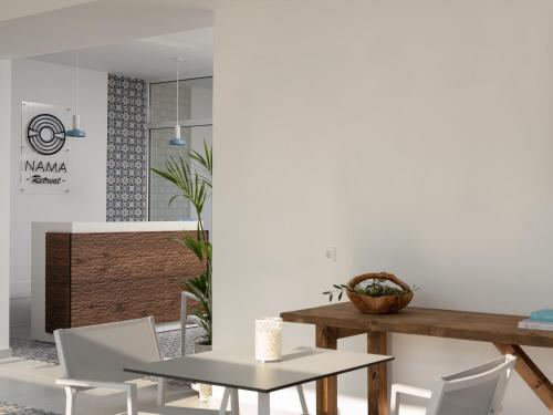 a dining room with a table and chairs at Nama Retreat in Pastida
