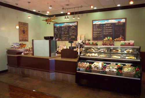 a bakery with a counter and a display case at Airtel Plaza Hotel in Van Nuys