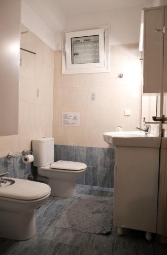 a bathroom with a toilet and a sink at Villa Eleni in Drosia