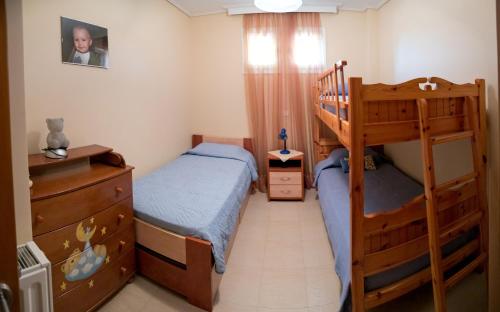 a bedroom with two beds and a bunk bed at Villa Eleni in Drosia