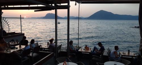 a group of people sitting at tables on a boat in the water at CHRYSSA - ΧΡΥΣΑ in Patra