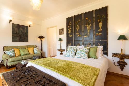 a bedroom with a large bed and a couch at Geronimo Guest House Belém in Lisbon
