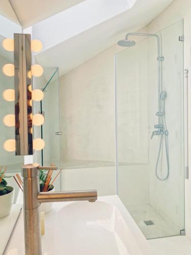 a bathroom with a shower with a glass door at Modern Beautiful House in Odeceixe