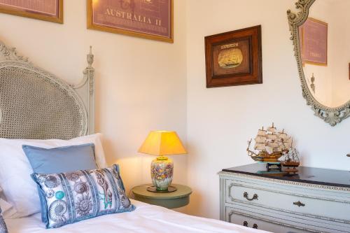 a bedroom with a bed and a table with a lamp at Geronimo Guest House Belém in Lisbon