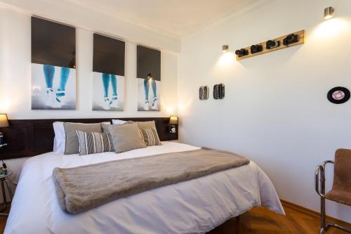 a bedroom with a bed with white sheets and pillows at Geronimo Guest House Belém in Lisbon