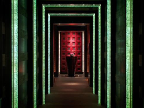 a hallway with a red door in a building at Four Seasons Hotel Hangzhou at West Lake in Hangzhou