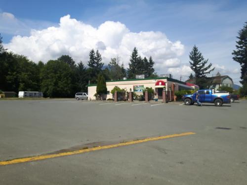 a blue truck parked in front of a gas station at Fuller Lake Chemainus Motel in Chemainus
