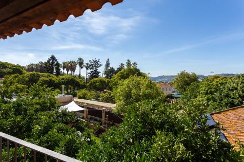 a view of a garden from the balcony of a house at Geronimo Guest House Belém in Lisbon