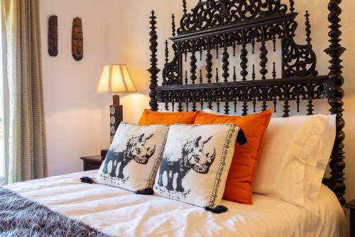 a bed with an ornate headboard and pillows at Geronimo Guest House Belém in Lisbon