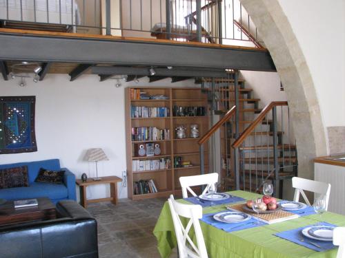 a living room with a table with a green table cloth at Dolphin Guest House and Studios in Tochni