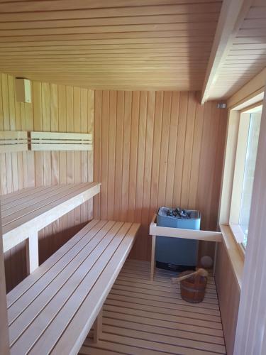 a small sauna with a bench and a blue cooler at Hier begint den hemel. in Beffe