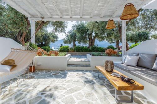 a patio with a couch and a hammock at Evlalia Studios & Villas in Skopelos Town