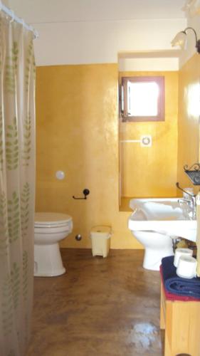 a bathroom with a white toilet and a sink at Madilì in Pantelleria