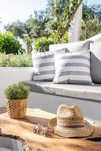 a hat and a pair of glasses and a table at Evlalia Studios & Villas in Skopelos Town